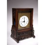 A CHINESE HARDWOOD TABLE CLOCK LATE QING DYNASTY The white enamel dial with Roman numerals,