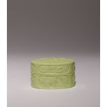 A CHINESE LIME GREEN OVAL BOX AND COVER LATE QING DYNASTY Moulded in relief with a figure of Han