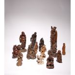 FOURTEEN CHINESE CARVED HARDWOOD AND BAMBOO FIGURES LATE QING DYNASTY Variously carved as Liu Hai,