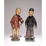 A PAIR OF CHINESE DOLLS 19TH CENTURY Standing on wooden bases, clothed in Chinese garments, the
