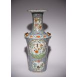 A CHINESE CANTON FAMILLE ROSE BLUE-GROUND VASE 19TH CENTURY Decorated with various shaped cartouches
