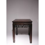 A CHINESE HARDWOOD LOW TABLE LATE QING DYNASTY The square panel top above a pierced frieze, raised