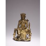 A CHINESE LACQUERED AND GILT-BRONZE FIGURE OF GUANYIN LATE MING DYNASTY Seated in lalitasana,