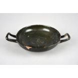 An Apulian black glazed kylix circa 350 - 300 BC the centre stamped with four linked acanthus