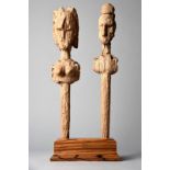 A pair of Bambara puppets Mali female and male, 50cm and 51.5cm high, in a hardwood stand. (3)