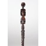 A Nyamwezi staff Tanzania with a carved standing figure terminal with inset bone disc eyes, above