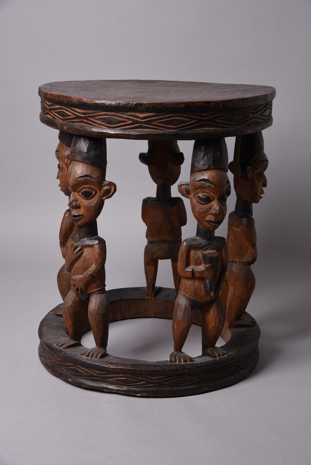 A Bamileke large stool Cameroon with five figural supports, two holding a horn, two with their hands - Image 2 of 2