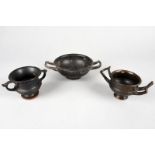 Three Apulian black glazed vessels circa 4th century BC including two kantharos, one with upturned
