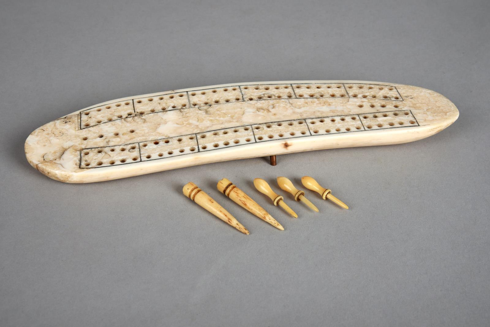 λAn Inuit cribbage board Arctic walrus ivory, with two copper pin supports, the underside