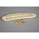 λAn Inuit cribbage board Arctic walrus ivory, with two copper pin supports, the underside