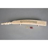 λAn Inuit cribbage board Arctic, early to mid 20th century walrus ivory, with a spiral carved end