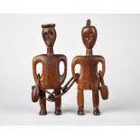 A pair of Zulu male and female figures South Africa united with a link chain and with snuff bottles,