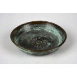 An Assyrian bronze shallow bowl circa 1000 - 700 BC with a central flowerhead motif, 12.5cm