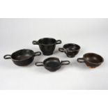 Five Apulian black glazed skyphoi circa 4th century BC including three with twin handles and two
