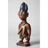 A Yoruba female Ibeji figure Baba Magba, Igbomina, Nigeria with Reckitts Blue to the coiffure and