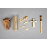 λAn Iniut bone scrapper pierced for attachment, 9.5cm long, a Sami carved bone, decorated a figure