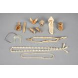 λA group of Inuit artefacts including two carved bone model caribou, 5.4cm and 5.5cm long, a