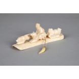 λAn Inuit group Arctic walrus ivory, of two figures on sleds and two dogs running, the underside