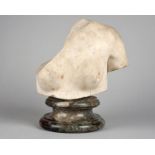 An antique marble female torso inscribed BERENIKH, 24.5cm high, mounted on a turned socle.