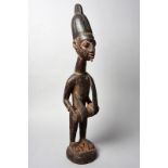 A Yoruba drummer figure Nigeria with a pigment finish, 76.5cm high.