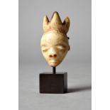 A Pende mask pendant gikhoko Democratic Republic of the Congo bone, with a three point headdress