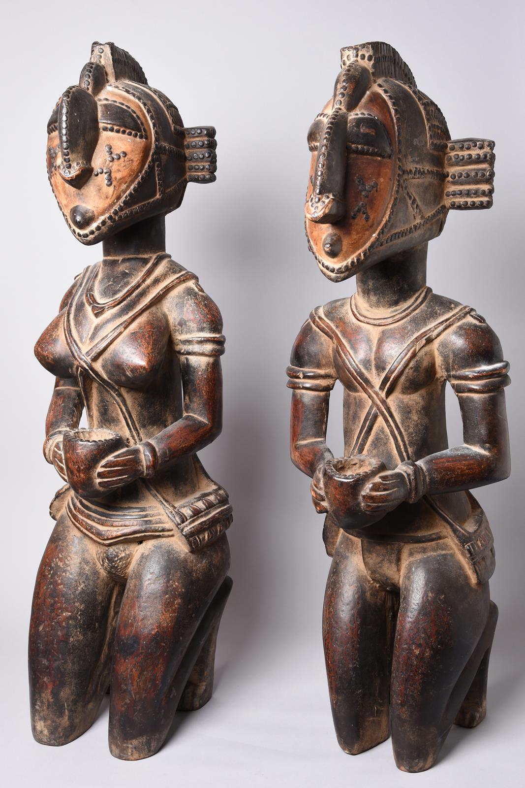 A pair of Baga kneeling offering figures Guinea male and female with metal studs to the heads and