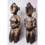 A pair of Baga kneeling offering figures Guinea male and female with metal studs to the heads and