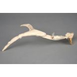 J Tobuk An Inuit carved group, 20th century antler, finely carved a polar bear head, a walrus, a