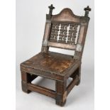 An Ashanti asipim chair Ghana with brass mounts and studs, the seat with hide webbing and cover,