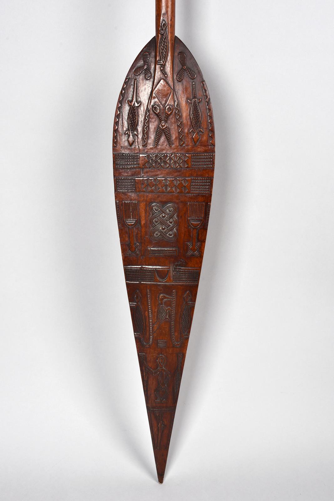 A Duala paddle Cameroon the blade with low relief carving of animals, padlocks, keys, scissors,