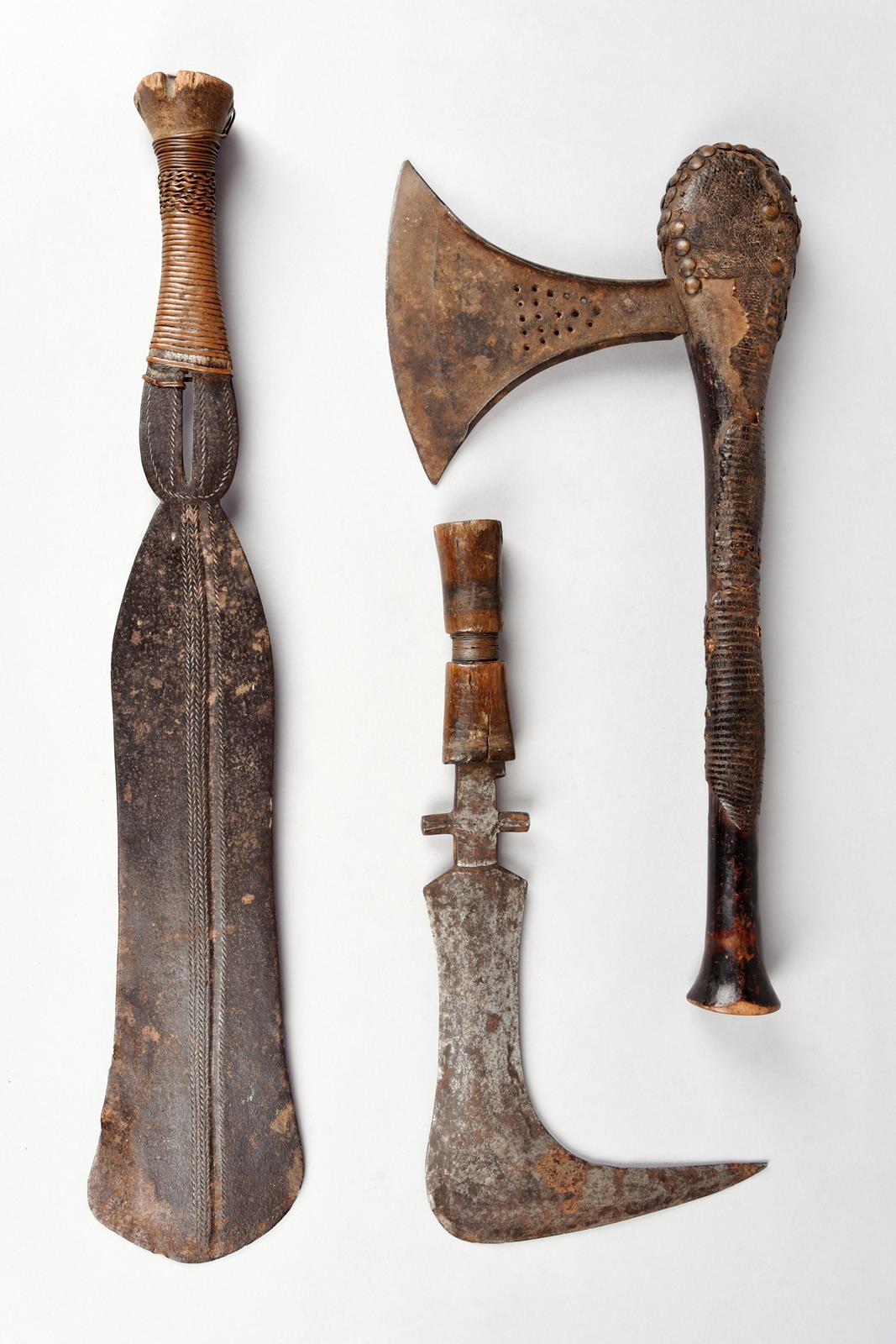A Songye axe Democratic Republic of the Congo with the remains of reptile skin and with brass studs,