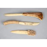 Three Inuit knives antler, two with carved decoration to the handle and one, Sami, incised on the