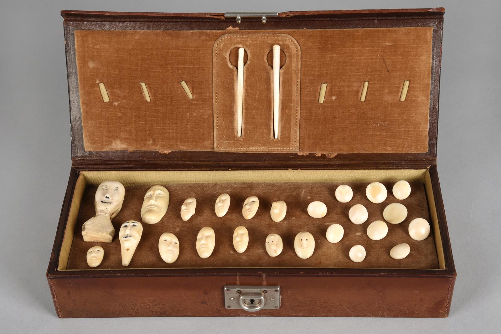 λA collection of Inuit buttons Alaska walrus ivory, including seven carved with human faces, three