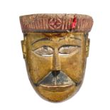 A Rajbansi mask Nepal with painted decoration, wearing a turban with a central circle and cross