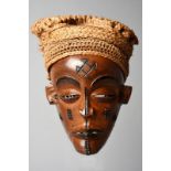 A Chokwe mask Democratic Republic of the Congo with a knotted raffia coiffure and scarifications
