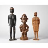 Two Madagascar female figures one with a banded headdress, headband and necklace, 35.5cm and 29cm