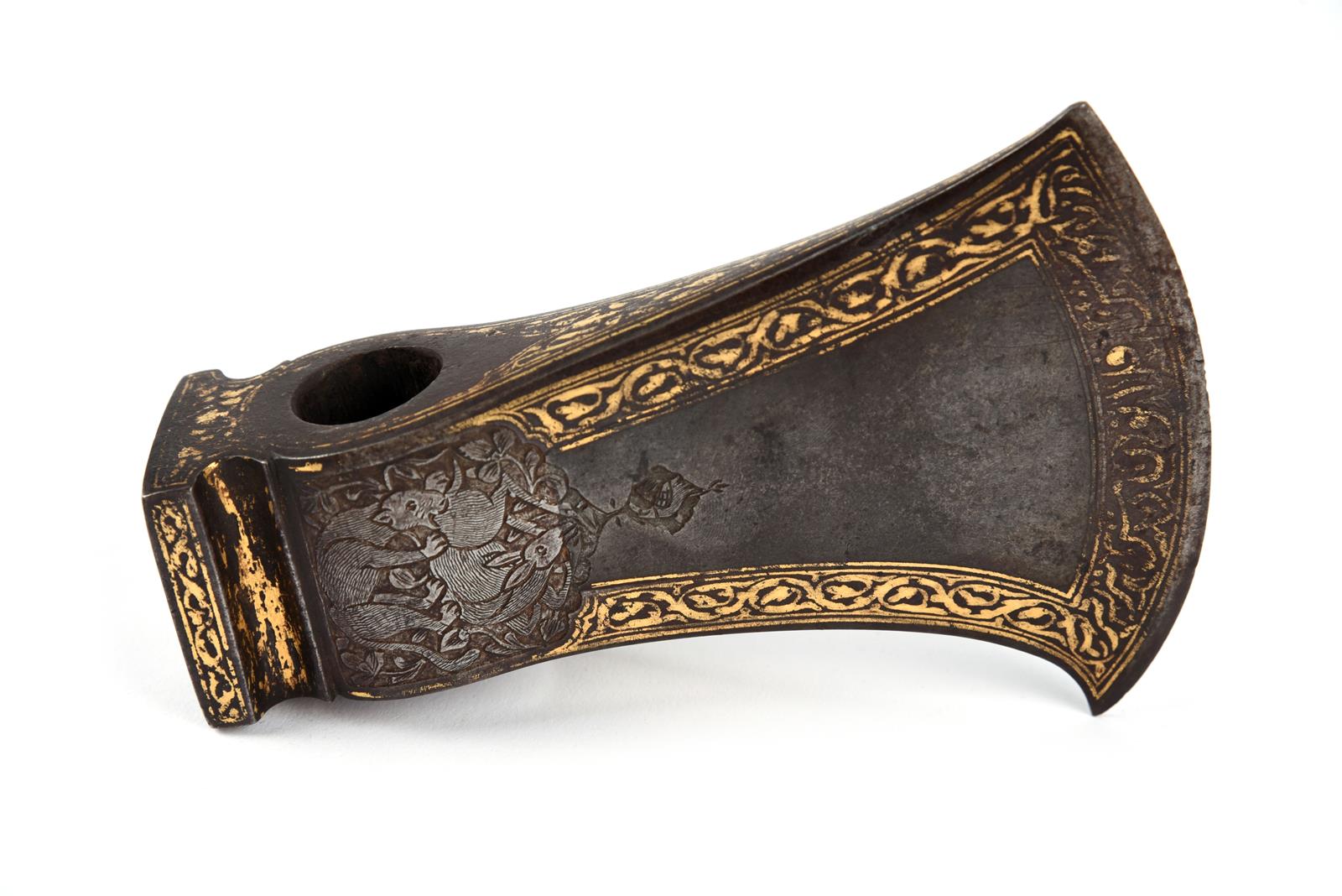 A fine Persian axe head (tabor), of watered steel with gold koftgari borders, the sides and back