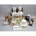 A quantity of reproduction Staffordshire figures and dogs, a pair of cats, a collection of
