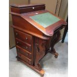 A reproduction hardwood davenport fitted with the usual arrangement of real and dummy drawers