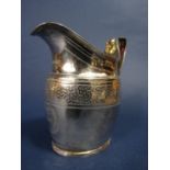 A good quality Georgian silver baluster cream jug with engraved bands and crest, maker Solomon