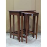 A nest of three Edwardian mahogany occasional tables of rectangular form raised on slender square