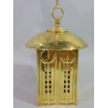 A Mackintosh style brass hall lantern of square form with pierced detail beneath a domed canopy,