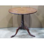A Georgian mahogany snap top occasional table of circular form, the one piece top 73 cm in