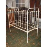 A Victorian cast iron cot with drop side, painted finish and sprung base