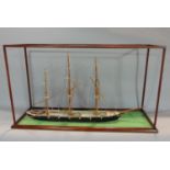 A late 19th century mahogany cased scale model of a three mast ship, the case 41 cm high x 73 cm