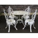 A cream painted cast aluminium garden terrace table of circular form with decorative pierced top and