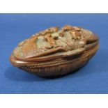 A good 18th century carved snuff box in coquille nut, the top bearing a whimsical scene with a
