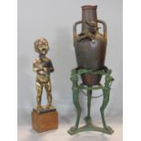 Unusual twin handled cast metal baluster pot mounted by a winged cherub set within a patinated metal
