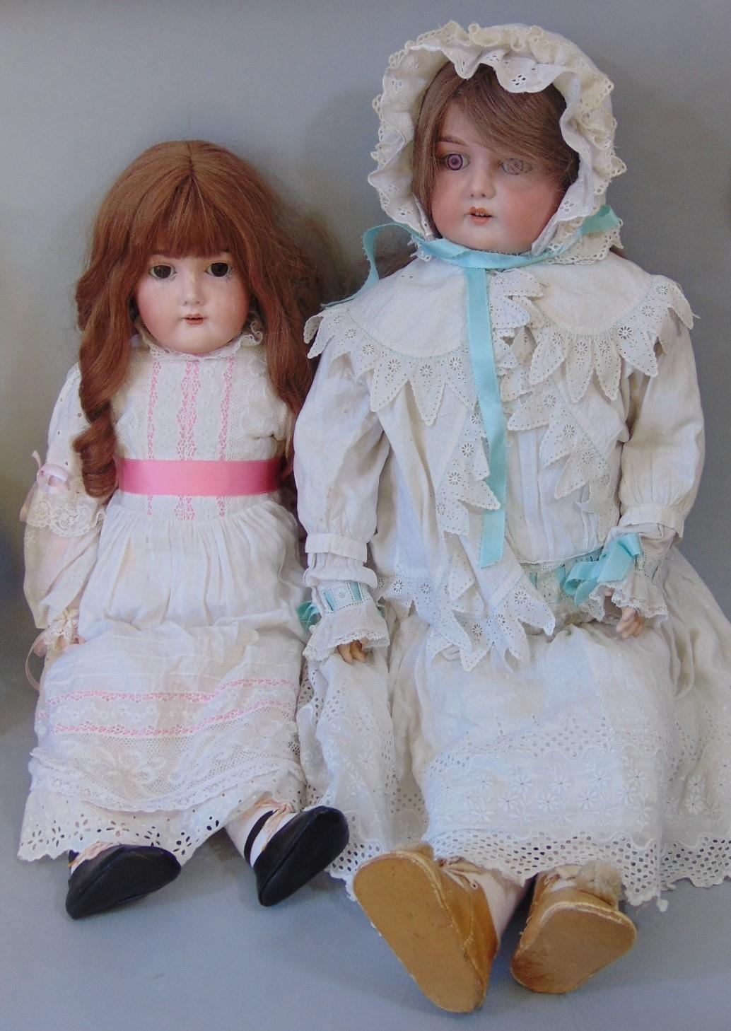 2 early 20th century dolls both with bisque socket heads and jointed composition bodies wearing