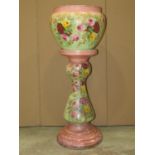 An Edwardian ceramic jardiniere and stand with transfer printed and painted floral detail